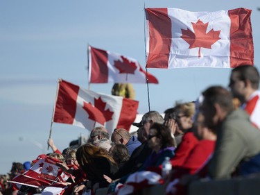 People gathered at Bankfield at the 416 to pay respects as the escort with the body of Nathan Cirillo is transported by hearse from Ottawa via Highway of Heroes to Hamilton on Friday, Oct. 24, 2014.