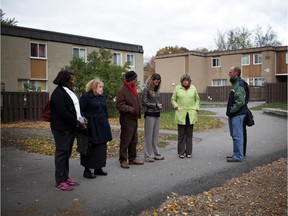 People take part in group prayer as they walk through Britannia Woods Community during a prayer walk organized on Sunday, October 19 2014.