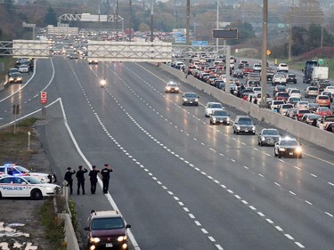 People show their support at the Whites Road overpass in Pickering as a procession of vehicles returns the remains of Cpl. Nathan Cirillo to Hamilton, Thursday October 24, 2014. Cpl. Cirillo was killed while on guard at the National War Memorial in Ottawa.