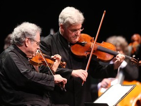 Pinchas Zukerman (R) plays with Itzhak Perlman at the NAC Gala at the National Arts Centre in Ottawa, October 02, 2014.