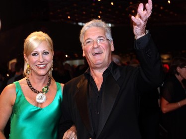 Pinchas Zukerman, respected violinist, violist, conductor and outgoing music director of the National Arts Centre Orchestra, waves to the crowd on the red carpet with his cellist wife, Amanda, at the start of the NAC Gala held Thursday, Oct. 2, 2014.