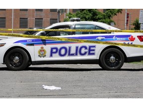 Police are investigating a homicide which happened on Besserer St. in front of Les Suites Hotel in Ottawa, Saturday, June 7, 2014. A police cruiser and scene tape protect evidence in the Arts Court parking lot one block north of the stabbing scene. Eighteen-year-old Brandon Volpi, of St. Patrick's High School was stabbed to death around 3:30am. The incident followed a high school prom, investigators say. Mike Carroccetto / Ottawa Citizen