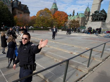 Police clear the crime scene at the War Memorial as police respond to an apparent terrorist attack in Ottawa.