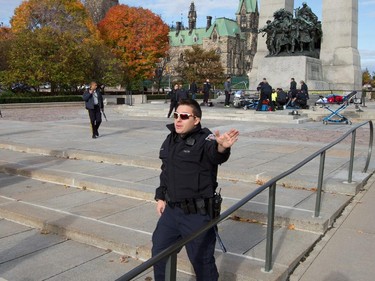 Police clear the crime scene at the War Memorial as police respond to an apparent terrorist attack in Ottawa.