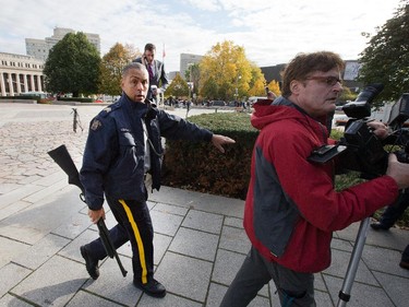 Police clear the crime scene at the War Memorial as police respond to an apparent terrorist attack in Ottawa.