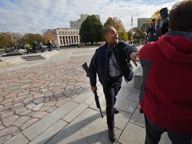 Police clear the crime scene at the War Memorial as police respond to an apparent terrorist attack in Ottawa.