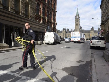 Police cordon off a street leading to Parliament Hill in Ottawa on Wednesday Oct.22, 2014. A Canadian soldier standing guard at the National War Memorial in Ottawa has been shot by an unknown gunman and there are reports of gunfire inside the halls of Parliament.