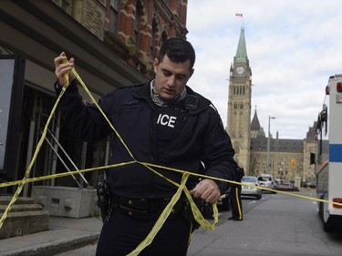 Police cordon off a street leading to Parliament Hill in Ottawa on Wednesday Oct.22, 2014. A Canadian soldier standing guard at the National War Memorial in Ottawa has been shot by an unknown gunman and there are reports of gunfire inside the halls of Parliament.