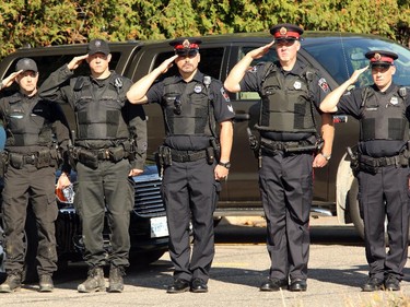 Police salute the procession carrying the casket of Cpl. Nathan Cirillo out of McEvoy-Shields funeral home in Ottawa Friday afternoon as it starts its escorted procession home to Hamilton October 24, 2104.