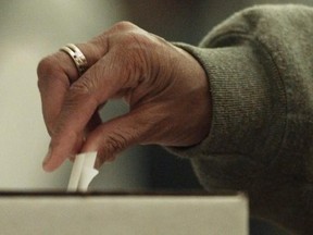 prv093000voting03 : SEE CITY SISE STORY BY WENDY MCLELLAN - SEPT. 30, 2000 - SURREY, B. C. -  An  woman places her ballot in the box during the provincial Liberal nomination battle in Surrey-Tynehead riding held at North Surrey Secondary school.    Among the Candidaters were Mayor Doug McCallum and Dave Hayer.    ARLEN REDEKOP / PROVINCE [PNG Merlin Archive]--Federal Election 2006

VOTING