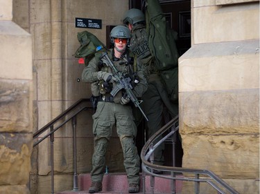 RCMP tactical officers attempt to enter the Langevin Block as police respond to an apparent terrorist attack in Ottawa.