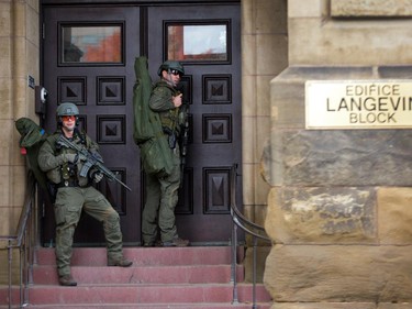 RCMP tactical officers attempt to enter the Langevin Block as police respond to an apparent terrorist attack in Ottawa.