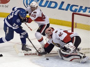 Ottawa Senators goalie Robin Lehner (40) and left wing Mike Hoffman (68) protect the net against Tampa Bay Lightning right wing J.T. Brown (23) during the first period of an NHL hockey game Saturday, Oct. 11, 2014 in Tampa, Fla.