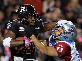 Ottawa Redblacks' Roy Finch gets tackled by Montreal Alouettes' Chip Cox.