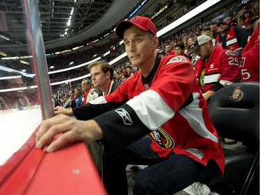 Sens fan Scott Scarrow is on the edge of his seat in the second period .