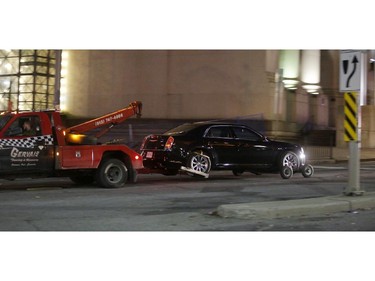 A Chrysler vehicle is towed away from Parliament Hill on October 22, 2014 in Ottawa, Canada. At least one gunman shot and killed a Canadian soldier standing guard at the National War Memorial before entering the House of Commons inside the main Parliament building and opening fire. The gunman, identified as Michael Zehaf-Bibeau, was shot and killed by law enforcement while still inside the Parliament building.