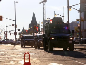 A tactical vehicle leaves the security perimeter on Wellington Street, just a couple blocks away from Parliament Hill, on October 22, 2014 in Ottawa, Canada. At least one gunman shot and killed a Canadian soldier standing guard at the National War Memorial before entering the House of Commons inside the main Parliament building and opening fire. The gunman, identified as Michael Zehaf-Bibeau, was shot and killed by law enforcement while still inside the Parliament building.