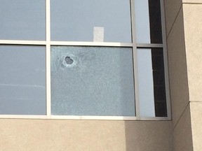 Damaged window at mosque at 1216 Hunt Club Rd.