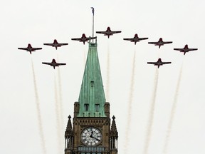 The Snowbirds Canadian aerobatic jets fly over the Peace Tower at the Canada Day celebrations on Parliament Hill.
