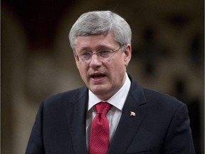 Canadian Prime Minister Stephen Harper speaks about the government's motion on a combat mission in Iraq following question period in the House of Commons Friday, October 3, 2014 in Ottawa.