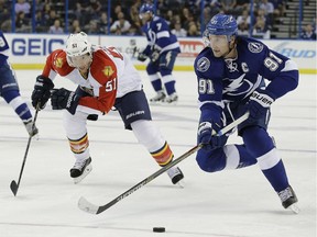 Tampa Bay Lightning center Steven Stamkos (91) gets ahead of Florida Panthers defenseman Brian Campbell (51) during the second period of an NHL preseason hockey game Saturday, Oct. 4, 2014, in Tampa, Fla.
