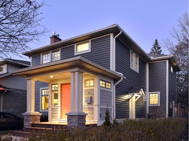 Gerhard Linse gave new life to a two-storey clapboard home, adding a red door, a new porch an charcoal siding.