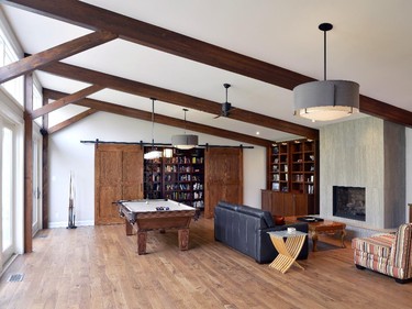 Gord Weima Design's transformation of an unused indoor pool into a family gathering spot with "secret library" hidden by sliding barn doors won in the category of renovation, $100,000 to $199,999.