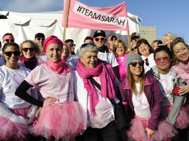Supporters of Sarah Taylor-Haddad, second from left front, gather with her before the start of the CIBC Run for the Cure in Ottawa on Sunday, October 5, 2014.
