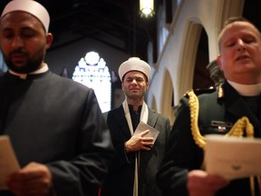 Tears roll down the cheeks of Imam Mohamed Jebara of the Cordova Spiritual Education Centre during an interfaith service, 'A Prayer for Ottawa' at Christ Church Cathedral Ottawa on Sunday, October 26, 2014.
