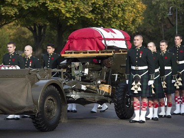 The flag-draped casket of Cpl. Nathan Cirillo is towed during his funeral procession.
