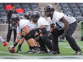 The offensive line including (from right) J'Michael Deane, Jon Gott and Alexander Krausnick as the Ottawa Redblacks practice at TD Place Wednesday.