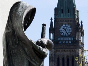 The statue "Truth" stands by the entrance of the Supreme Court of Canada in Ottawa on May 7, 2010.