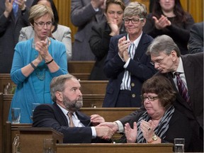 NDP leader Tom Mulcair is congratulated after speaking in the House of Commons Friday on Canada's role in Iraq.