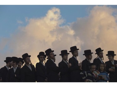 Ultra-Orthodox Jews pray on the Hayarkon river bank during a Tashlich ceremony in the Israeli town of Ramat Gan near Tel Aviv, Israel, Thursday, Oct. 2, 2014. Tashlich, which means "to cast away" in Hebrew, is the practice by which Jews go to a large flowing body of water and symbolically "throw away" their sins by throwing a piece of bread, or similar food into the water before the Jewish holiday of Yom Kippur.