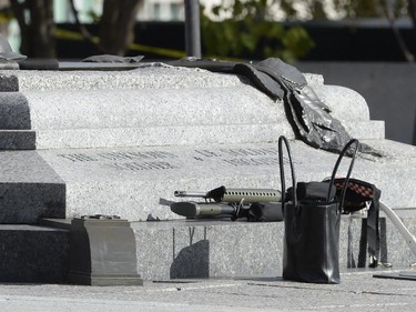 Weapons and personal belongings are pictured at the National War Memorial as police secure the area near Parliament Hill in Ottawa on Wednesday Oct.22, 2014. A gunman opened fire at the National War Memorial, wounding a soldier, then moved to nearby Parliament Hill and wounded a security guard before he was shot, reportedly by Parliament's sergeant-at-arms.