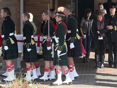 With family, Cpl. Nathan Cirillio's mother, Kathy Cirillo (right) follows the casket carrying her son, Cpl. Nathan Cirillo, out of McEvoy-Shields funeral home in Ottawa Friday afternoon as it starts its escorted procession home to Hamilton October 24, 2104.