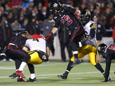 Zach Collaros of the Hamilton Tiger-Cats is sacked by Jovon Johnson of the Ottawa Redblacks during first half CFL action.