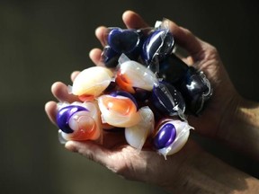 In this photo taken Friday, Nov. 7, 2014, laundry detergent packets are held for a photo, in Chicago. Accidental poisonings from squishy laundry detergent packets sometimes mistaken for toys or candy landed more than 700 U.S. children in the hospital in just two years, researchers report. Coma and seizures were among the most serious complications. (AP Photo/Charles Rex Arbogast)