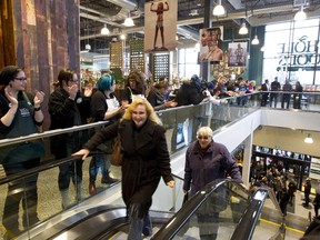 Eager customers take the escalator into the Whole Foods Market at Lansdowne Park Wednesday morning.