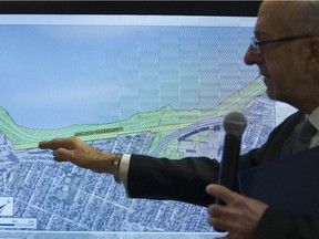 Arto Keklikian, principal transportation planner for the NCC with screen projection of area of contention where the NCC wants either the LRT to be underground or deviated across Rochester Field.