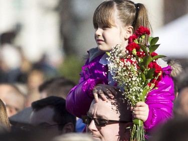 A girl gets a better view of the Remembrance Day ceremony at the National War Memorial in Ottawa Tuesday,