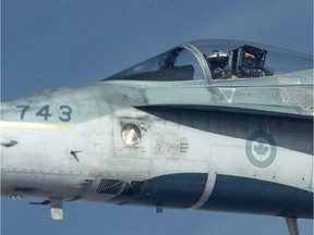 A Royal Canadian Air Force CF-18 Hornet is refueled by a KC-135 Stratotanker assigned to the 340th Expeditionary Air Refueling Squadron, Thursday, Oct. 30, 2014 over Iraq.