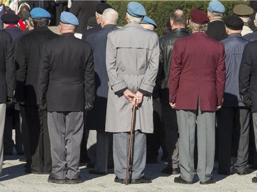 A veteran keeps his cane handy as the annual Remembrance Day Ceremony takes place at the National War Memorial in Ottawa.