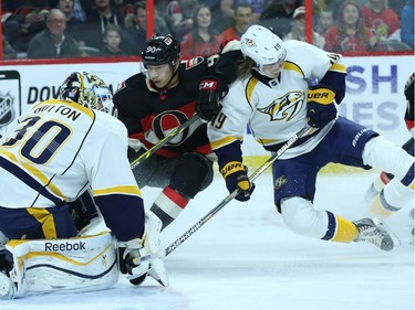 Alex Chiasson, middle, of the Ottawa Senators drives to the net of Carter Hutton of the Nashville Predators as he is defended by #19 Calie Jarnkrok during first period NHL action.