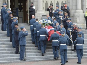 An honour guard stands at attention as warrant officer Patrice Vincent's casket is brought into a cathedral in Longueuil, Que., Saturday, Nov. 1, 2014.The 53-year-old Vincent was killed after being hit by a car driven by an attacker with known jihadist sympathies on Oct. 20 in the parking lot of a shopping mall in Saint-Jean-sur-Richelieu, southeast of Montreal.