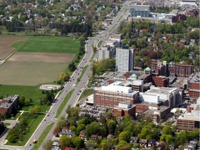 Carling Ave looking west toward the Queensway: the Experimental Farm is on left and The Ottawa Hospital's Civic Campus is on the right.