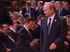 Russia's President Vladimir Putin, right, arrives as , left to right, Canada's Prime Minister Stephen Harper and US President Barack Obama look on during the G20 Summit "welcome country" ceremony at the Brisbane Convention and Exhibition Center on November 15, 2014 in Brisbane.