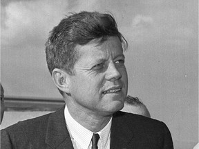 In this April 28, 1961, file photo, President John F. Kennedy stands during a welcoming ceremony at Chicago's O'Hare Airport. In the Trump era, writes Andrew Cohen, Kennedy's stature looms even larger