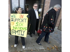 Six Nations supporter Jamie Clause (LEFT) looks on Six Nations Chief Ava Hill (RIGHT) and Chief Bryan LaForme (CENTRE) of the Mississauga New Credit out front of Brantford's Ontario Court of Justice after a judge dismissed the CAS request to force a 11 year old aboriginal girl to receive chemotherapy, Friday November 13, 2014.  [Peter J. Thompson/National Post]