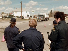 Custom Officers await for one of a dozen grain trucks crossing the border to the United States at Coutts, Alberta, on Jan. 1, 2004., to protest the Canadian Wheat Board monopoly of grain exports to the U.S.